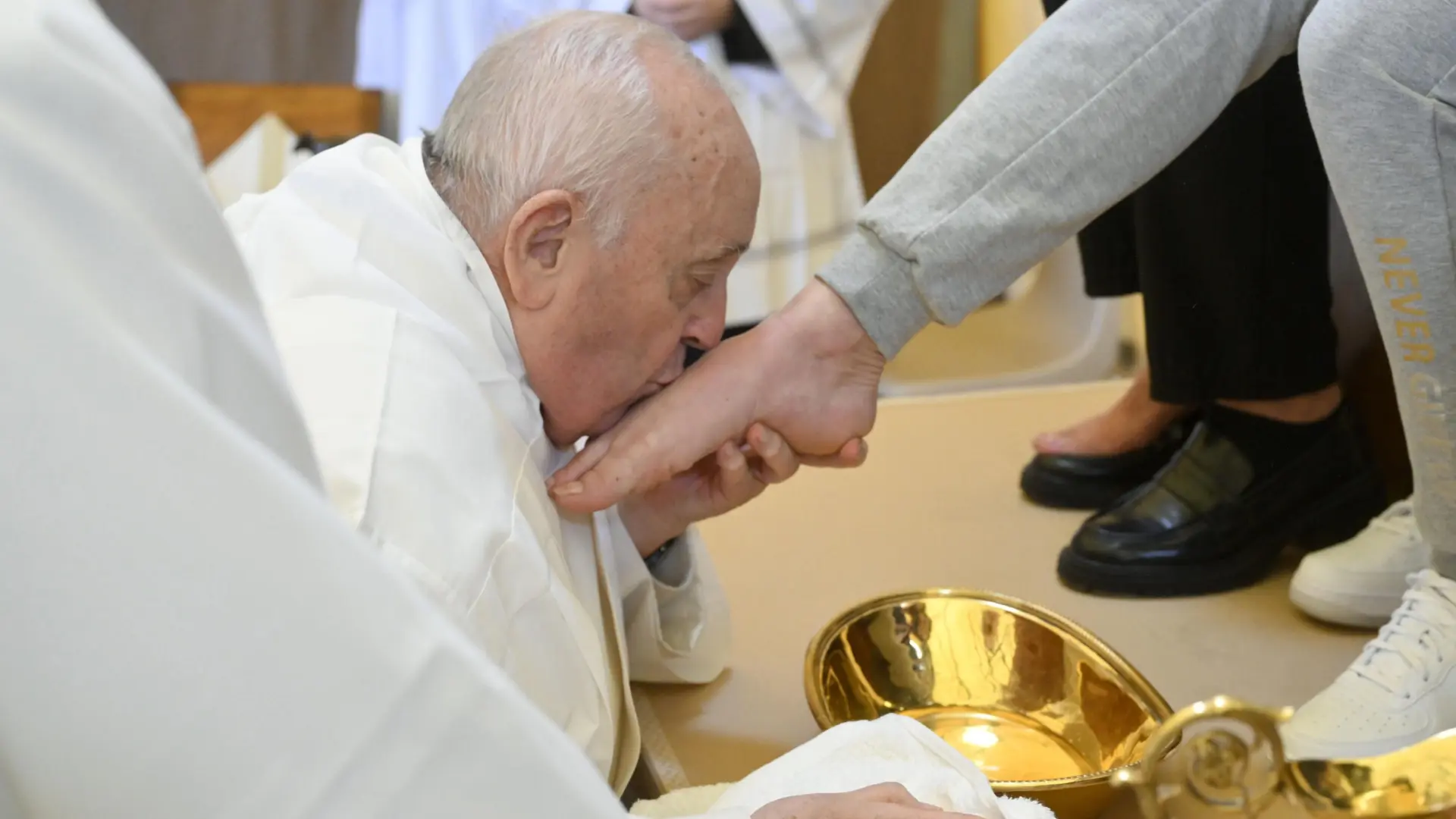 Pope Francis washes the feet of twelve inmates in wheelchairs on Holy Thursday