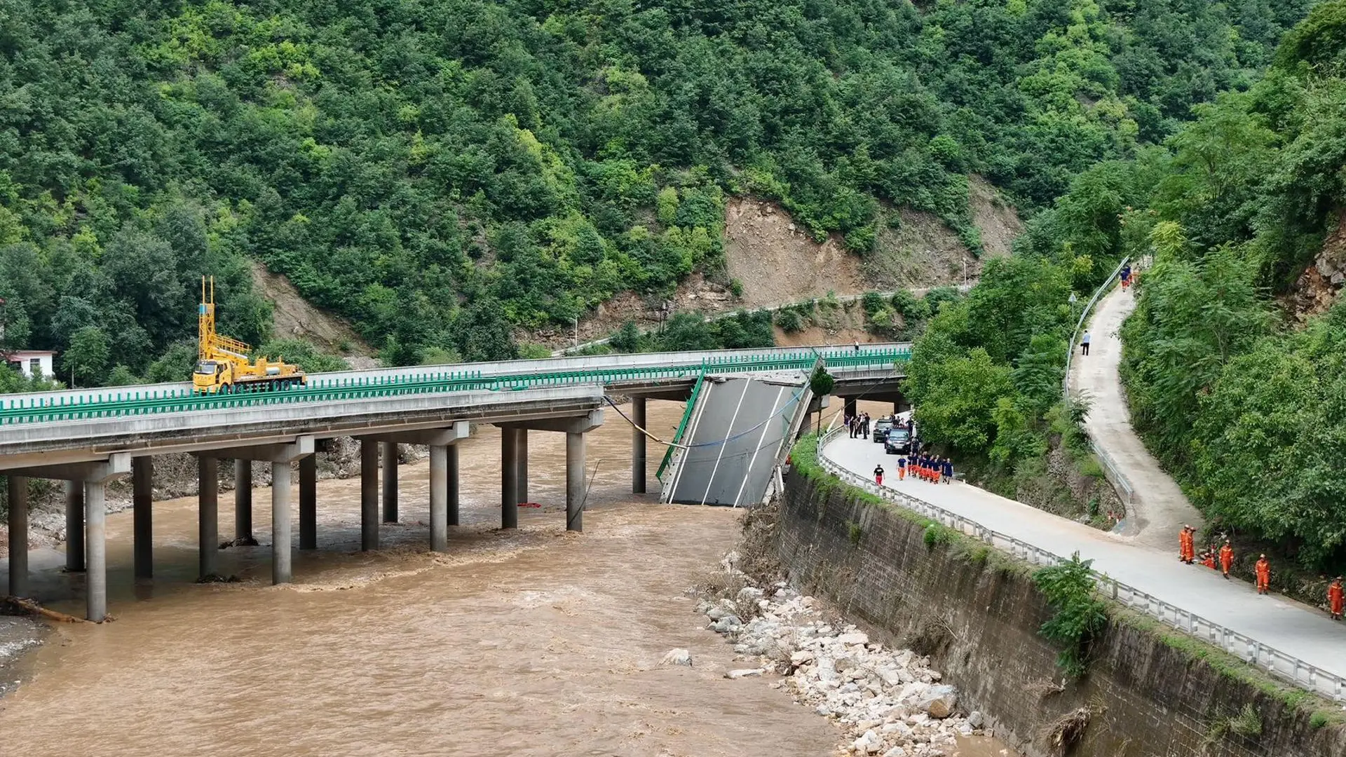 At least 12 dead and more than 30 missing after a bridge collapsed due to heavy rains in China