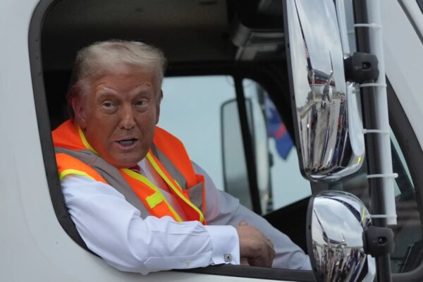 Trump arrives at rally in garbage truck after Biden's criticism